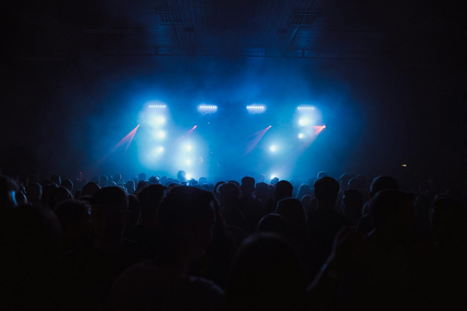 Crowd watching a lit stage